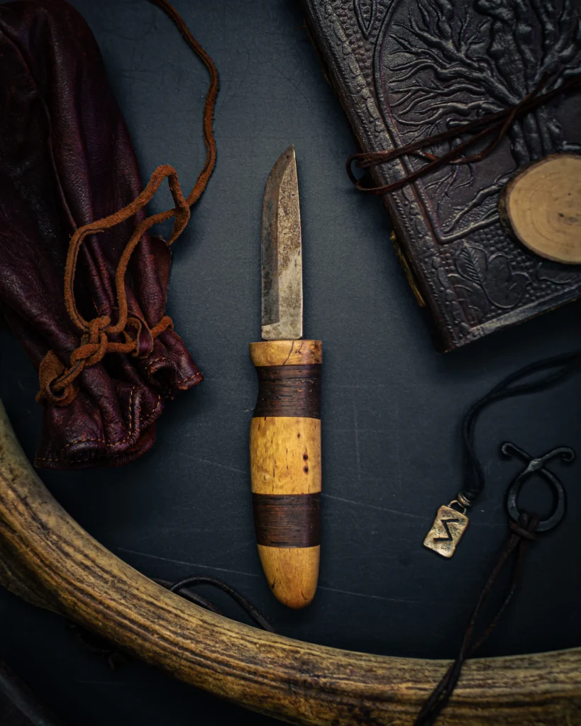 Fixed-blade knife with a leather sheath on a table