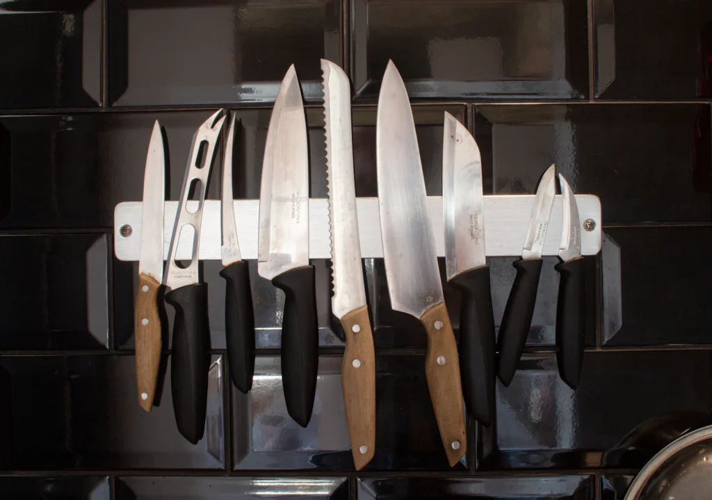 Kitchen knives stored on a magnetic knife strip