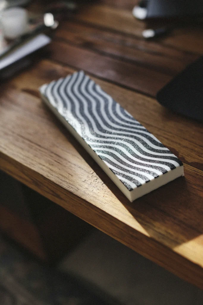 Knife being sharpened on a whetstone